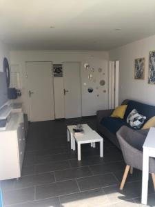 a living room with a couch and a coffee table at Cap Paradise suite jacuzzi in Cap d'Agde
