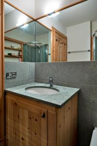 a bathroom with a sink and a mirror at Chesa Pradatsch Sur - Celerina in Celerina