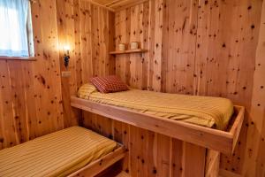 two bunk beds in a log cabin bedroom at Chesa Pradatsch Sur - Celerina in Celerina