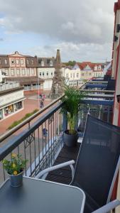 a balcony with a table and a view of a city at Hotel Paula Norderney in Norderney
