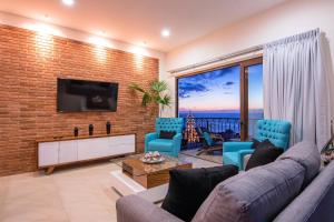 sala de estar con sofá y TV en una pared de ladrillo en NISE, en Puerto Vallarta