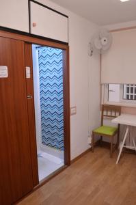 a room with a door with a glass window at ArArAt Hostel in Santiago de Compostela