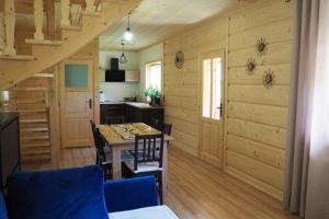 a kitchen and dining room with a table and chairs at Domek Pod Ubocom in Zakopane