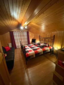 a bedroom with a bed and a chair in a room at Chalet Burglauenen Grindelwald in Grindelwald