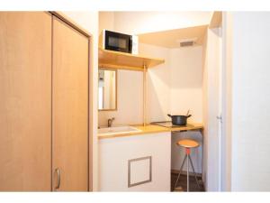 a small kitchen with a sink and a microwave at BEYOND HOTEL Takayama 2nd - Vacation STAY 82237 in Takayama