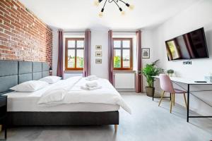 sypialnia z dużym łóżkiem i ceglaną ścianą w obiekcie Blick Apartments - Riverview Soft Loft w mieście Zgorzelec