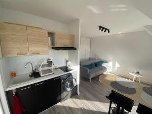 a small apartment with a kitchen and a dining room at Escapade à Cabourg, 300M plage, calme et chaleureux in Cabourg