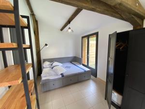 a bedroom with a bed in a room at La Fournière de Jean - La Téouleyre in Saint-Julien-en-Born