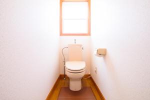 a bathroom with a white toilet with a window at Minamitsuru-gun - House - Vacation STAY 82283 in Fujikawaguchiko