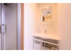a bathroom with a sink and a mirror at BEYOND HOTEL Takayama 3rd - Vacation STAY 82215 in Takayama
