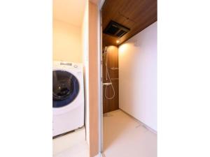 a laundry room with a washer and dryer at BEYOND HOTEL Takayama 3rd - Vacation STAY 82211 in Takayama