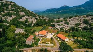 an aerial view of a house on a mountain at Apartments EcoNature in Virpazar