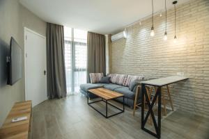 a living room with a couch and a table at New Wave 1 in Batumi