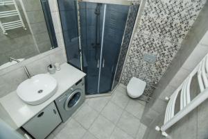 a bathroom with a sink and a shower at New Wave 1 in Batumi +25 photos
