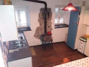 uma cozinha com um fogão a lenha num quarto em La casa di Nonna Nilla em San Giovanni Bianco