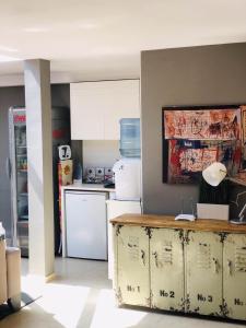 a kitchen with a counter and a white refrigerator at Executive Rooms and Suites Play in Veliko Tŭrnovo