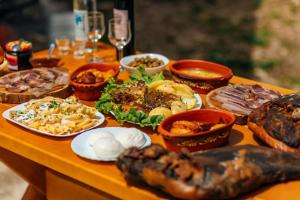 a table filled with different types of food at Apartments EcoNature in Virpazar