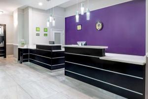 a dressing room with purple walls and benches at La Quinta by Wyndham Alamo-McAllen East in Alamo