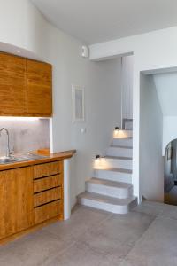 a kitchen with stairs and a sink and a stair case at LevandaMykonos in Mýkonos City