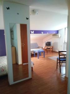 a living room with a bed and a table in a room at Apartments Milica in Umag