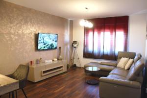 a living room with a couch and a table at Apartment Grbin in Pula