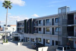 un edificio bianco con auto parcheggiate in un parcheggio di Hotel Pacific a Tijuana