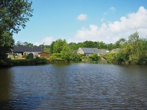 a view of a river with houses in the background at Vakantiehuis Jade in Bruinisse