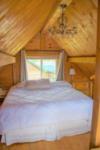 ein Schlafzimmer mit einem Bett in einer Holzhütte in der Unterkunft Homer Floatplane Lodge in Homer