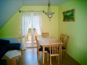 a dining room with a table and chairs and a window at Weingut - Ferienhaus Sonja Rohrbacher in Gamlitz