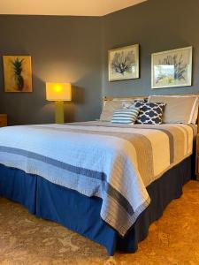 1 dormitorio con 1 cama grande con manta azul en Perfect for families and couples - Maui Sunset A-203 en Kihei