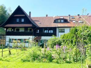 a large house with a garden in front of it at Ferienwohnung Christel in Wasserburg am Bodensee
