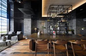 a dining room with a large wooden table and chairs at Hotel Resol Akihabara in Tokyo