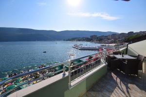 a balcony with a view of a body of water at Apartmani Amor in Herceg-Novi