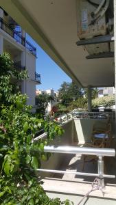 a balcony with a table and a chair on a building at Apartment Valeriana in Herceg-Novi