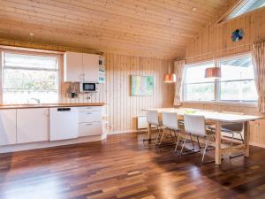 a kitchen with a table and chairs in a room at Secluded Cozy Cottage in Skaven-By Traum in Tarm