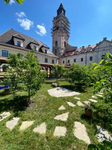 a courtyard with a building and a tower at Spadok in Kamianets-Podilskyi