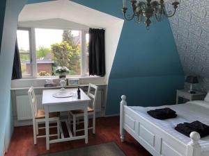 En eller flere senge i et værelse på B&B De Gouden Vlo