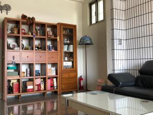 a living room with a couch and a book shelf at Fu Courtyard Homestay in Shuishang
