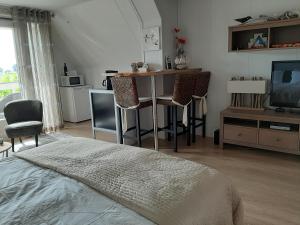 a bedroom with a bed and a table and chairs at In de Wolken in Giessenburg