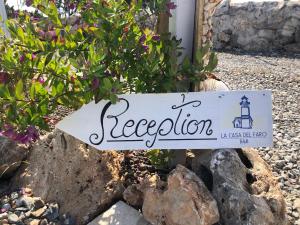 una señal para unas vacaciones en algunas rocas en B&B Casa del Faro SanVallero Adults Only, en Portopalo di Capo Passero