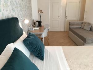 a bedroom with a bed with a couch and a table at Affreschi a San Pietro in Rome