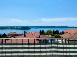 a view from a fence of a house and a lake at Apartment Rustica in Portorož