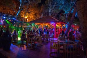 a group of people sitting at a bar at night at Apartmani Zuzana in Baška Voda