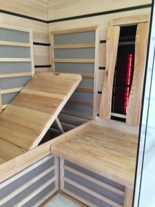 a room with a table and benches in a tiny house at Davidslids cottage in Löddeköpinge +21 photos