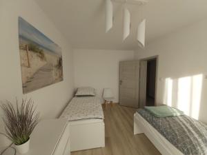 Łóżko lub łóżka w pokoju w obiekcie Apartament Przy Lesie Słoneczne Tarasy