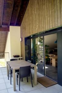 a dining room with a table and some chairs at La Champanaise - 2 bedroom apartment 300m from Lake Annecy in Duingt