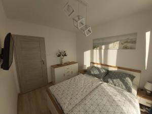 Łóżko lub łóżka w pokoju w obiekcie Apartament Przy Lesie Słoneczne Tarasy