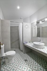 a bathroom with a toilet and a sink at Fantasia Villas Deluxe "Galene" in Panormos Kalymnos