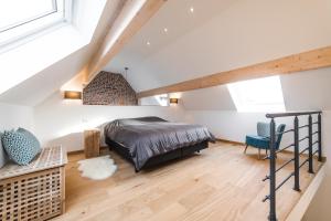 een slaapkamer met een bed en een loft bij Le Cabri Ô Lait in Namen