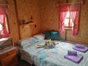 a bedroom with a bed with a bowl of food on it at Vikendica RANKOVIĆI in Mokra Gora